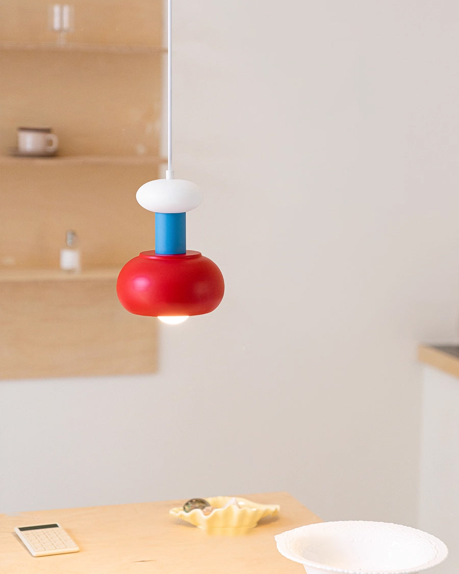 Side view of the Meli Pendant Light, highlighting its blue, red, and white sections.
