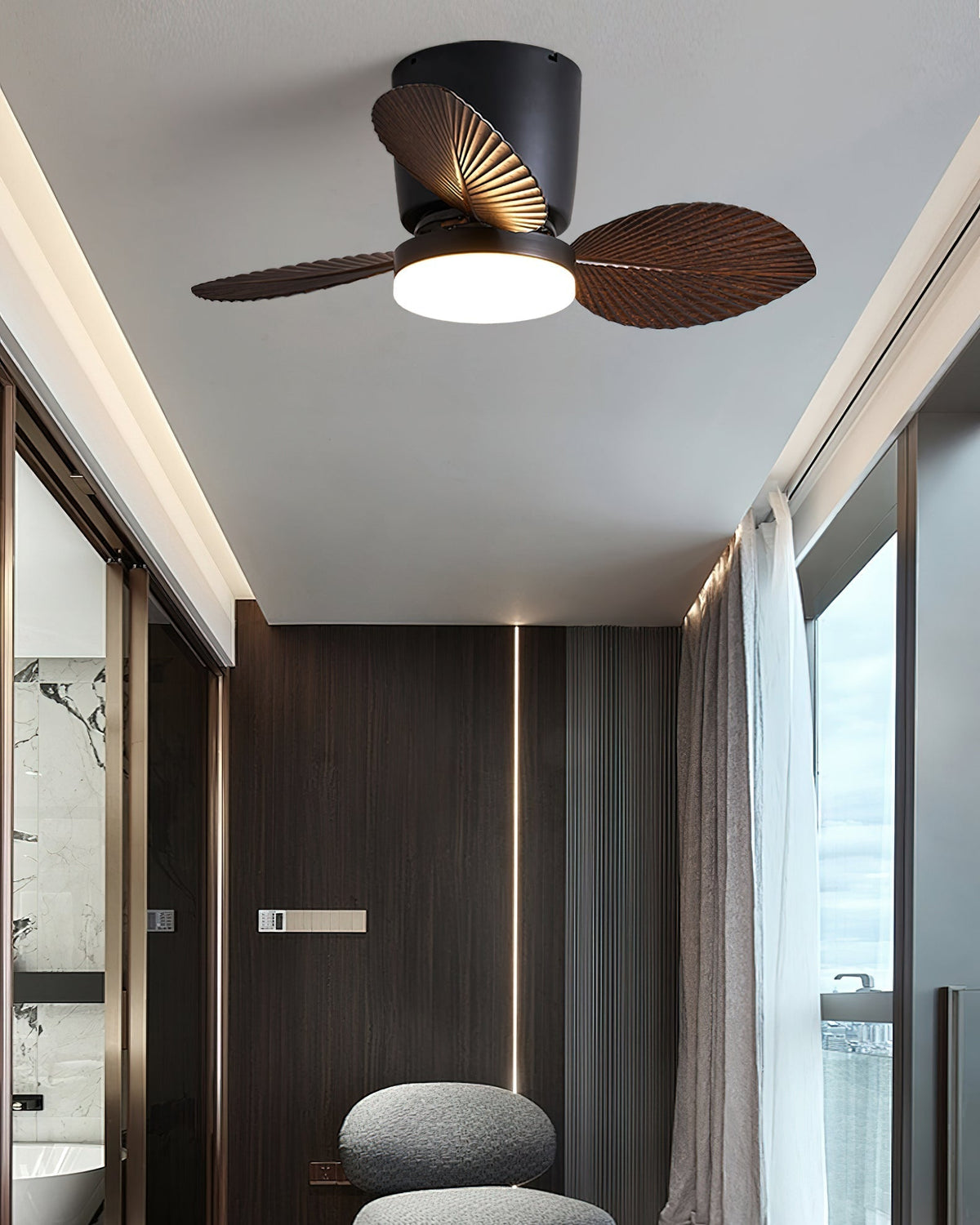 The walnut finish Melorie fan in a tropical-themed sunroom.