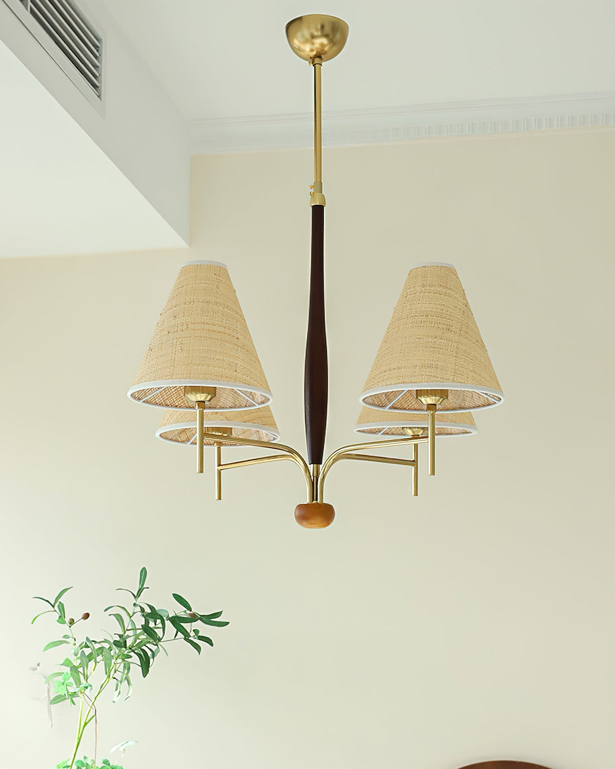 Close-up of the gold metal finish on the chandelier's structure.