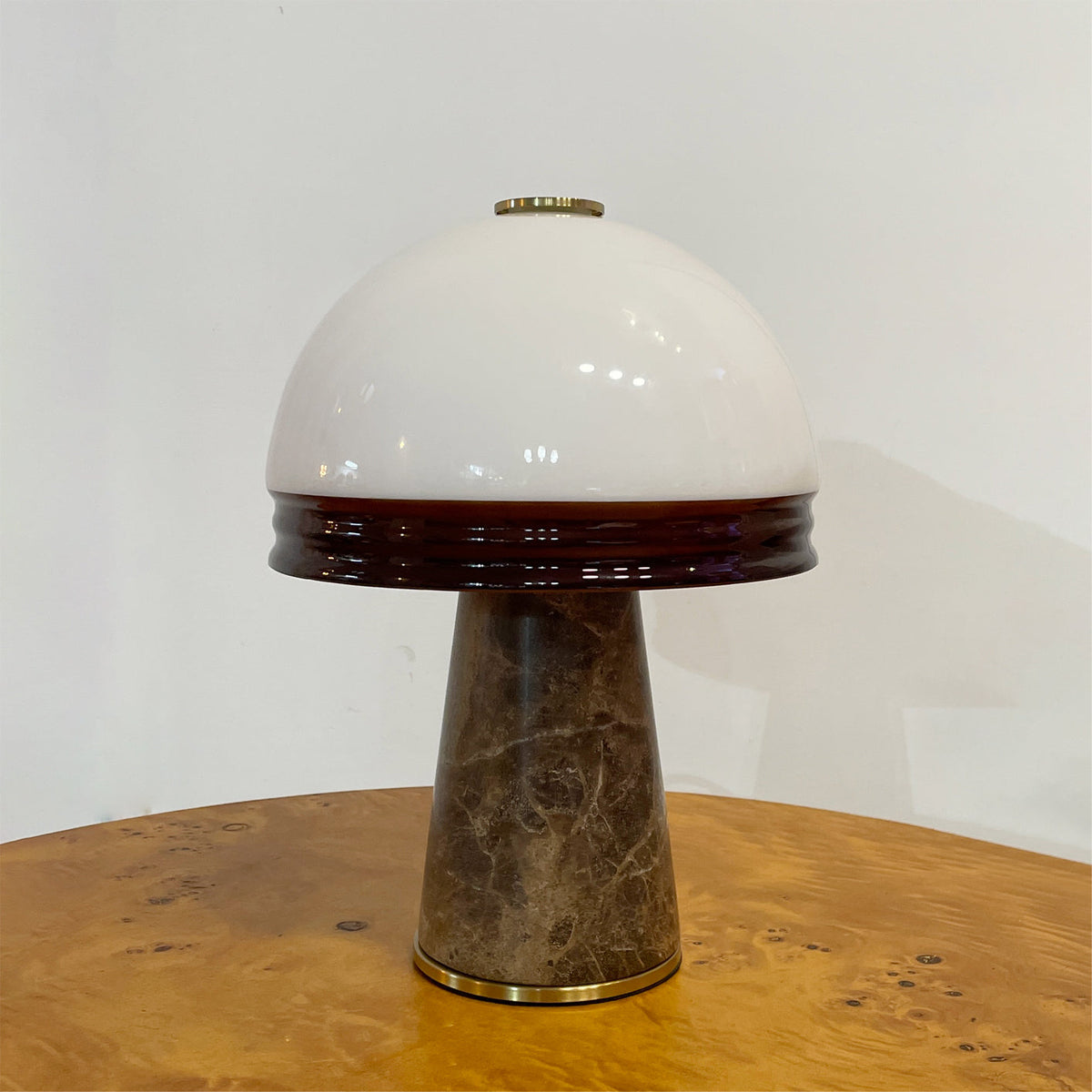 Milano Table Lamp displayed on a nightstand, providing soft ambient light.