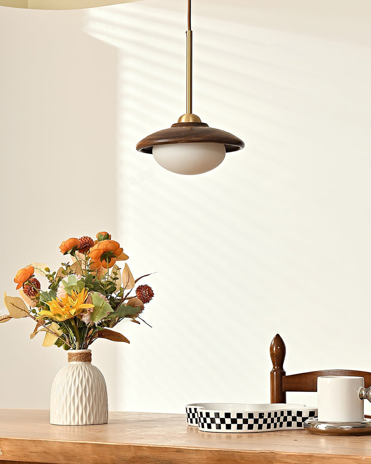 The Milivia Pendant Light illuminated, showing its soft, warm glow.