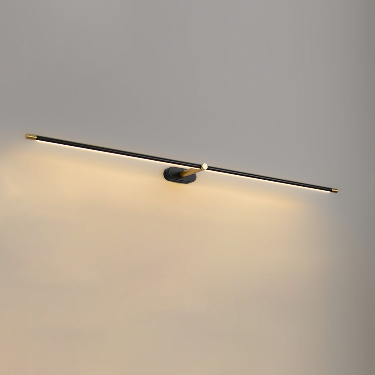Close-up of the gold finish on the minimalist wall lamp.