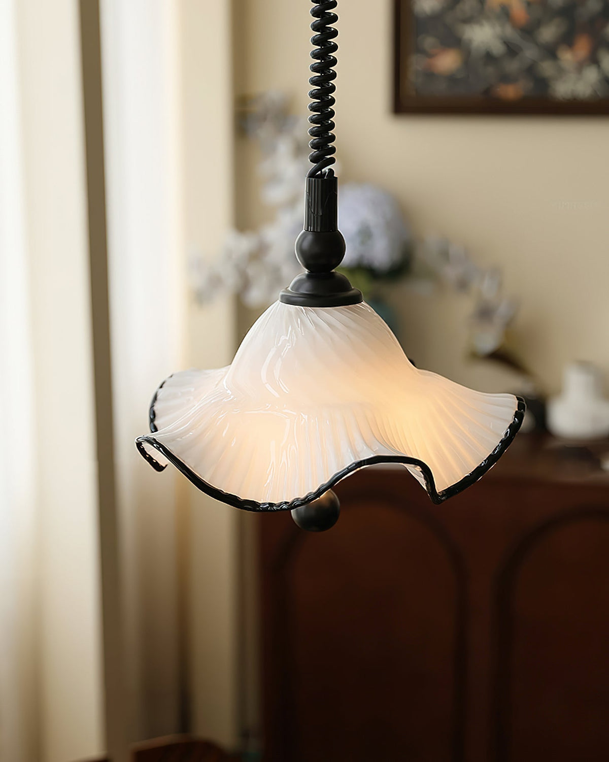 Close-up on the sleek chrome hardware of the pendant light.
