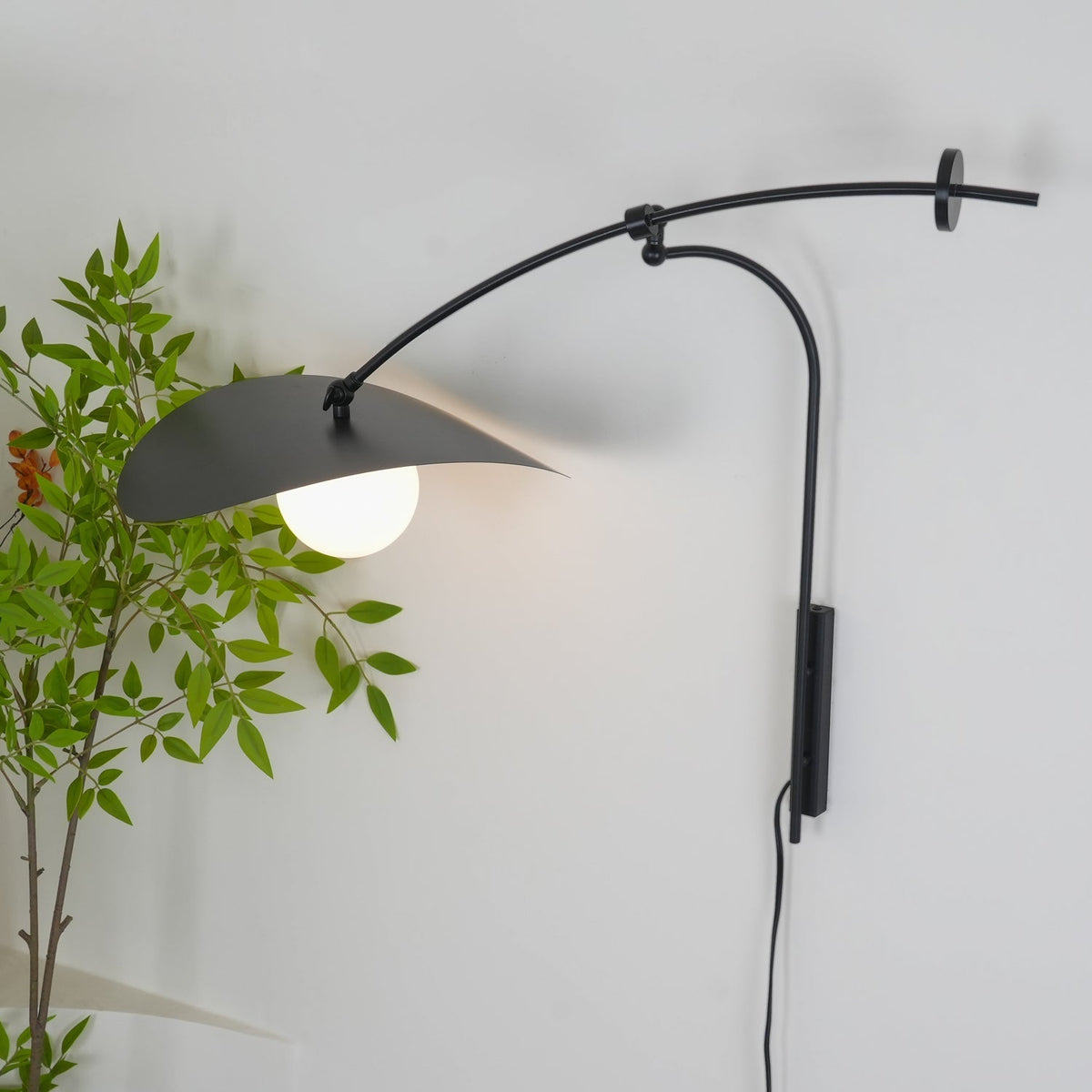 Angled view of the Myrna Plug-In Wall Lamp.