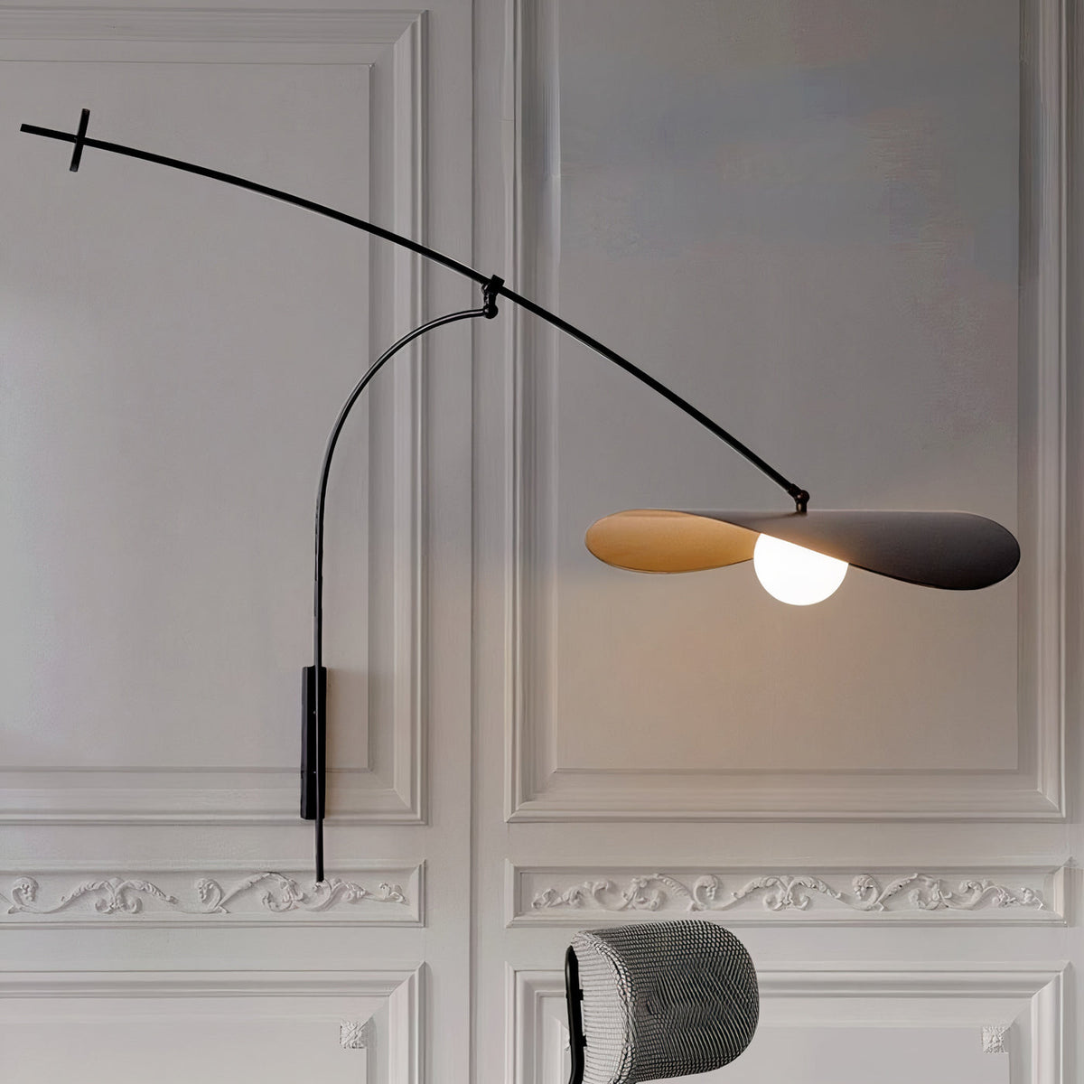 The large size Myrna Wall Lamp installed above a modern sofa.