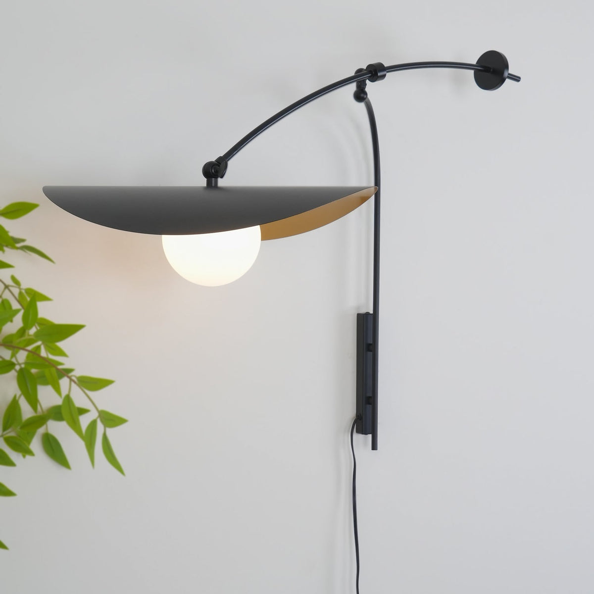Side view of the Myrna Plug-In Wall Lamp showcasing its sculptural form.