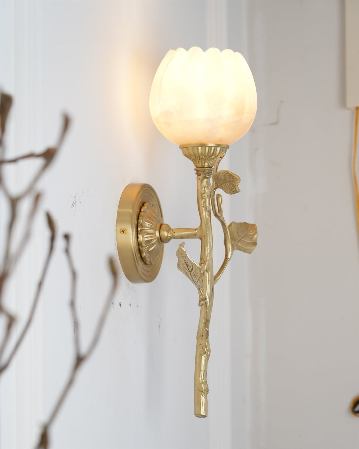 The Natalia Wall Sconce illuminated, casting a soft and warm glow.
