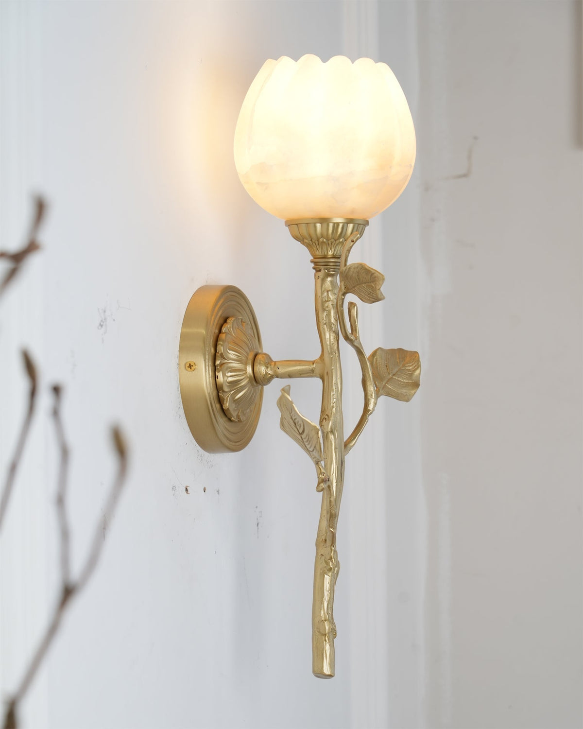 Angled photograph emphasizing the sculptural and organic form of the wall light.