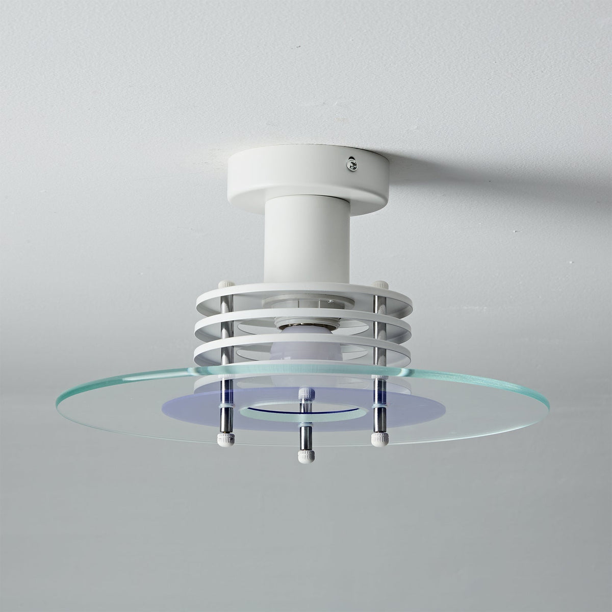 The Nello Ceiling Lamp shown in a minimalist interior setting.