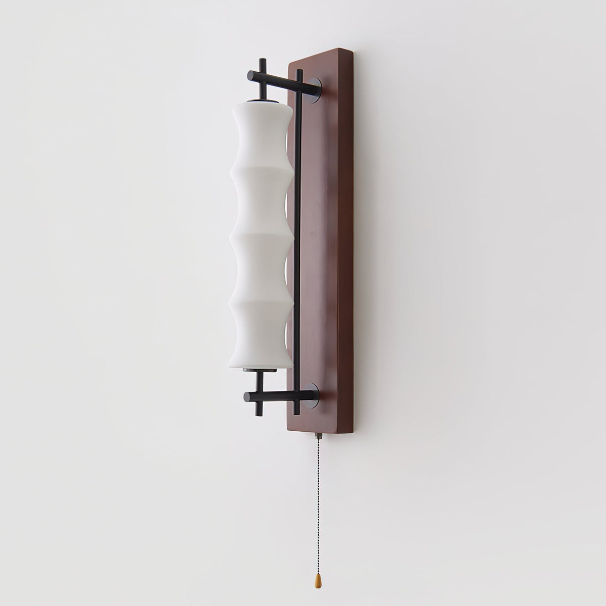 The Nesta wall sconce shown in the walnut color finish.