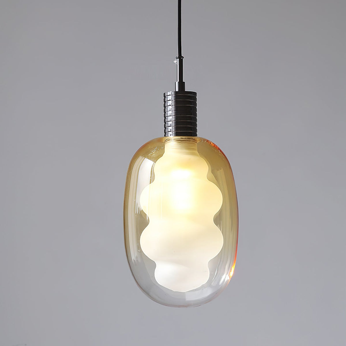 Niche Pendant Light shown in a modern dining area setting.