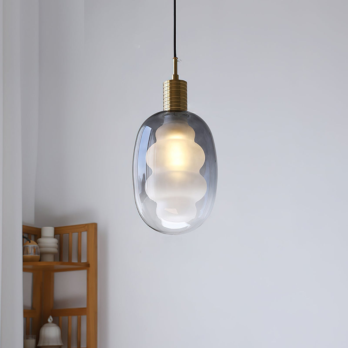 Niche Pendant Light with gold and black metal accents.