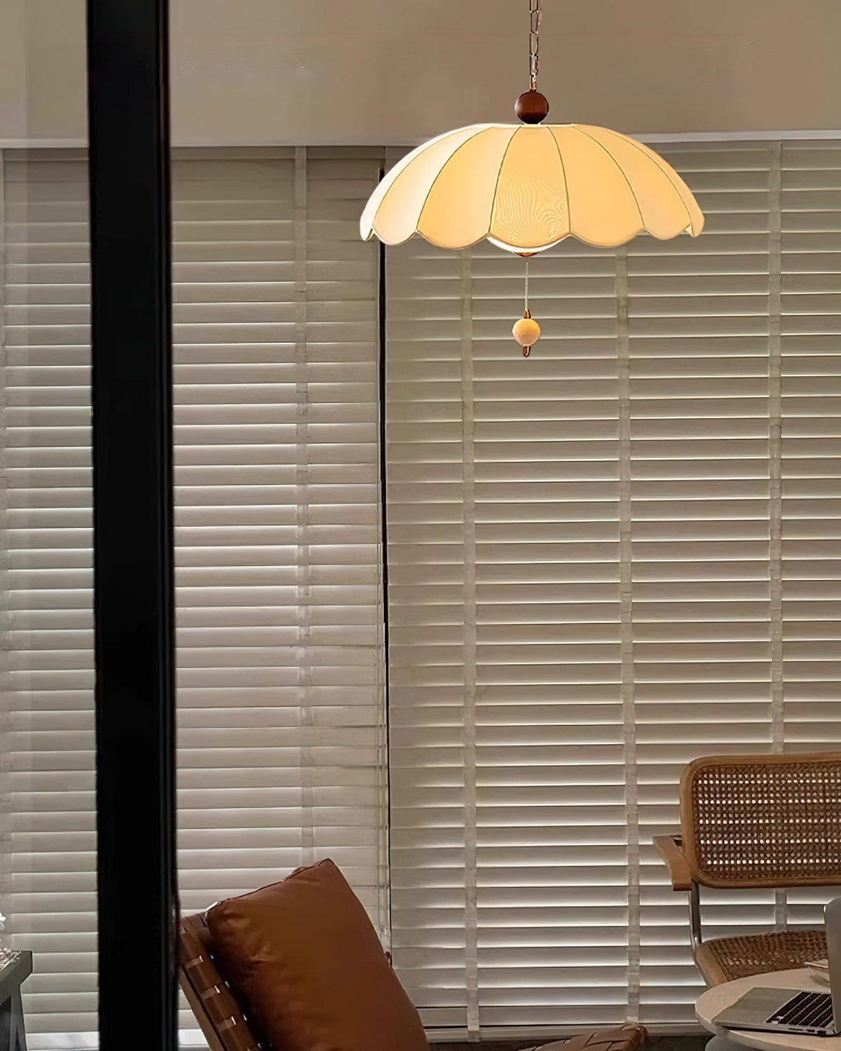 Oriente Pendant Light hanging over a dining table.