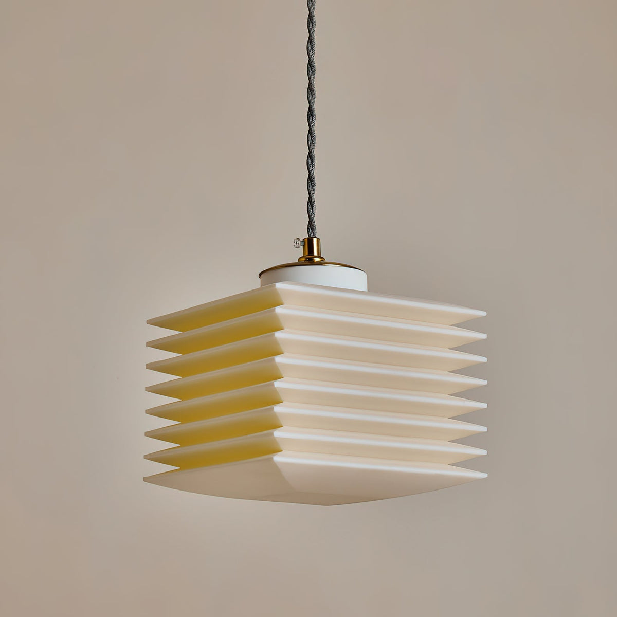 The Pagoda Pendant Lamp illuminated, showing its geometric form.
