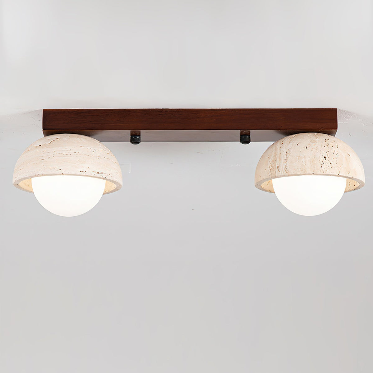 Close-up of a single travertine dome shade on the Palermo ceiling light.
