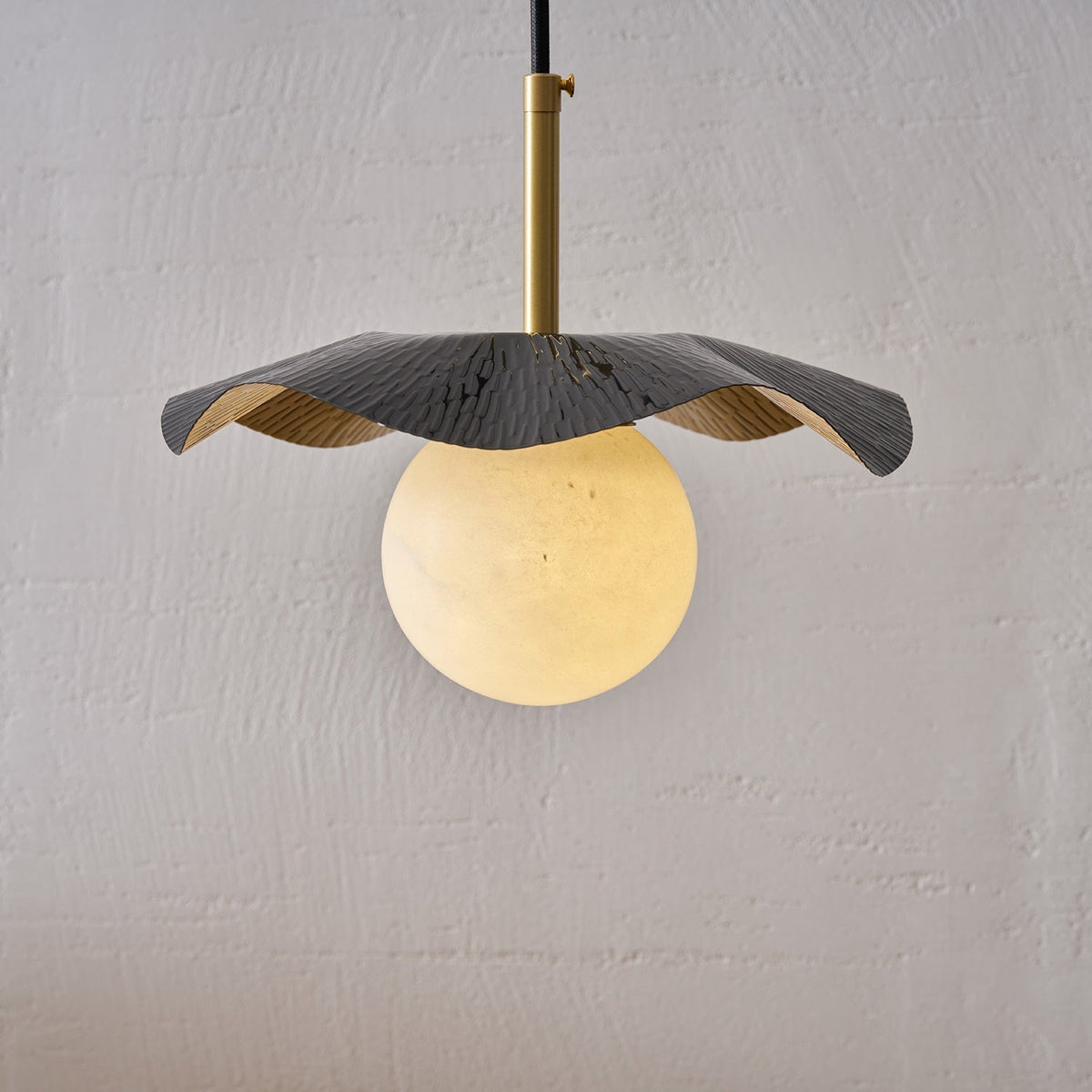 Side profile of the Bonnie Alabaster Pendant Lamp showcasing its form.