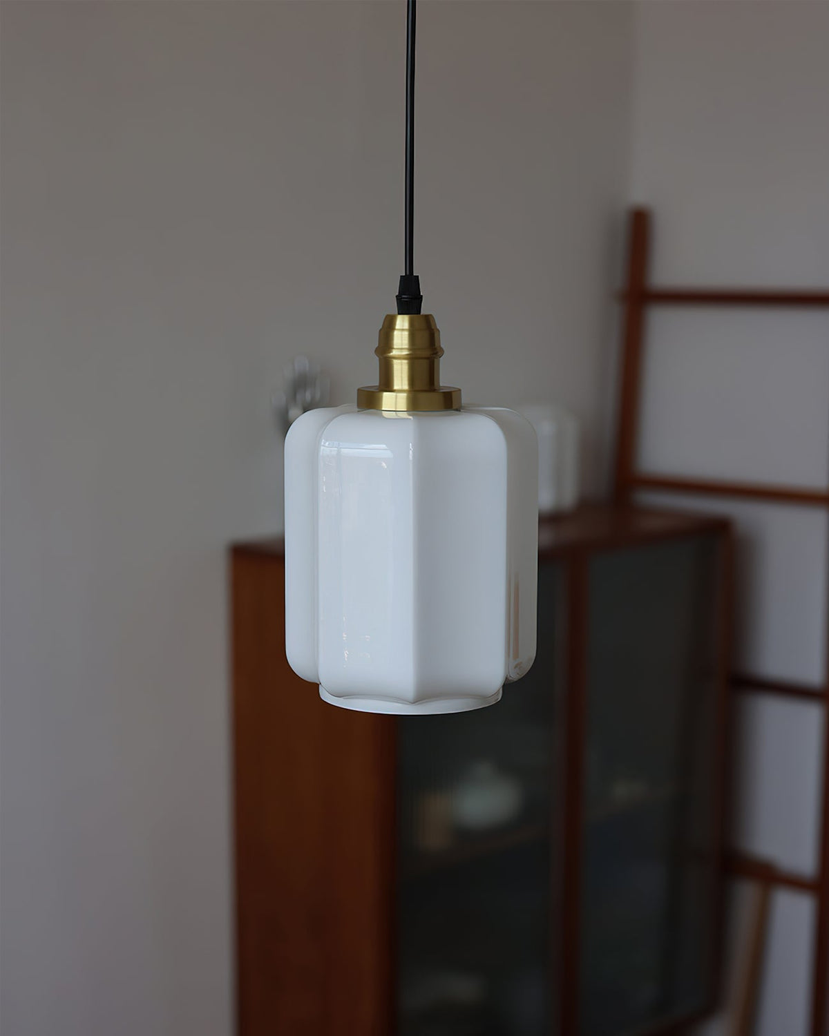 Angled view of the Model A pendant light, highlighting its wide, curved shape.