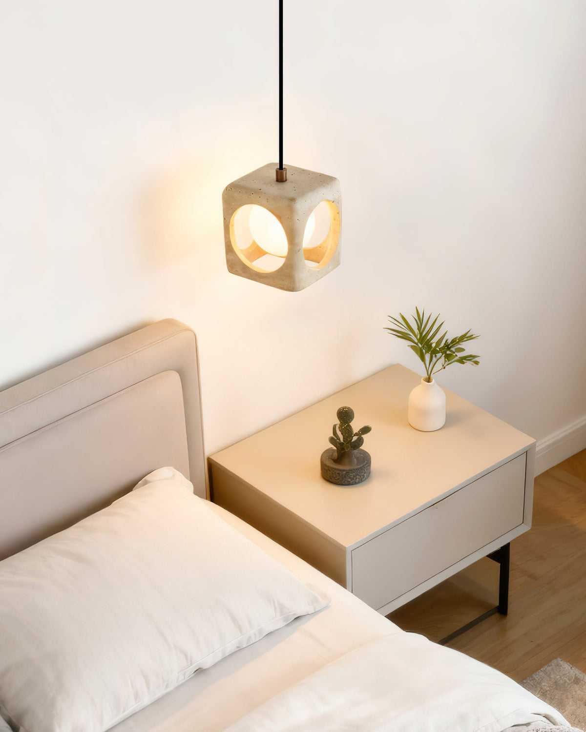 Lifestyle view of the single pendant light in a modern bedroom.