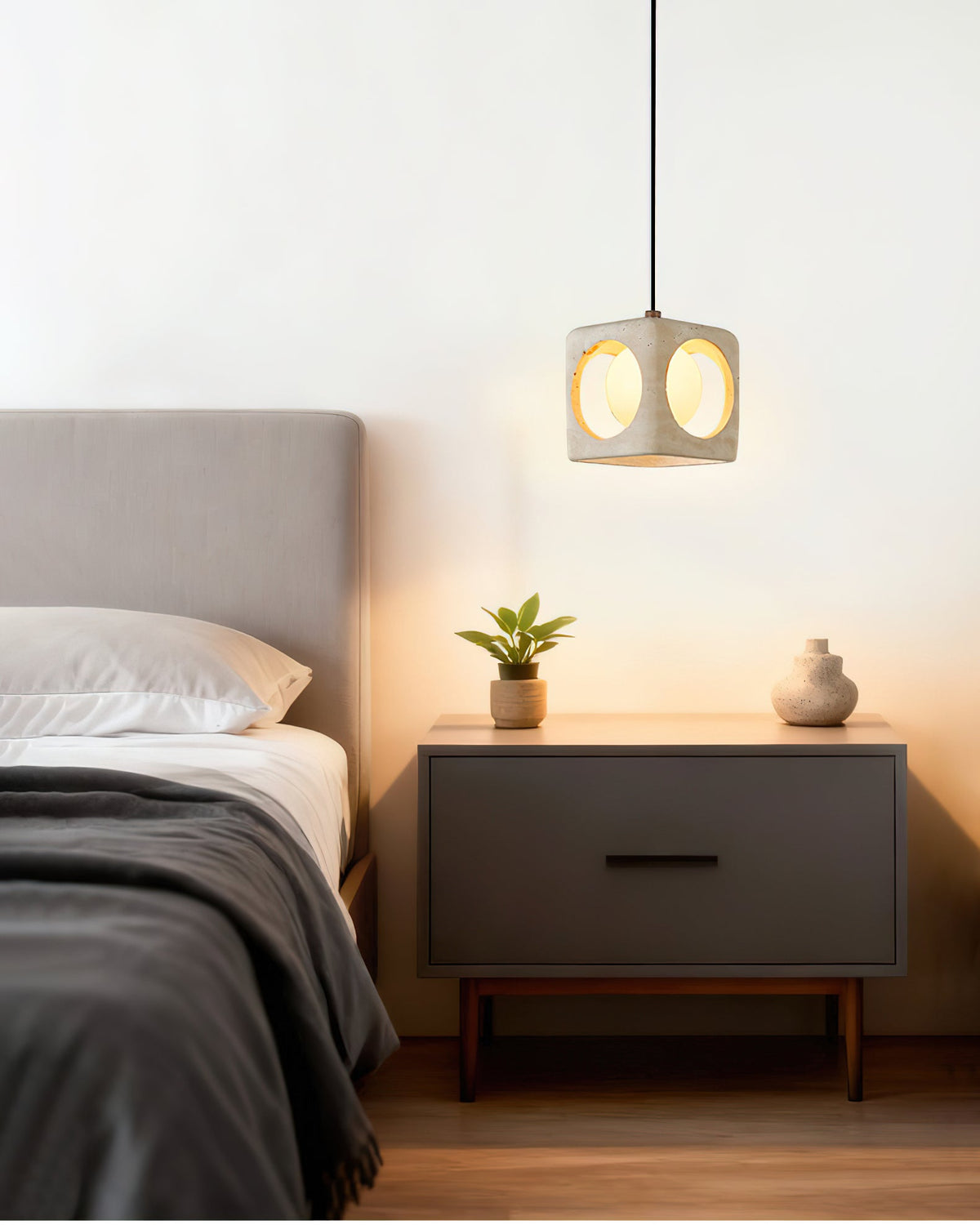 The Remodern pendant light illuminated, showing the soft glow through the stone.