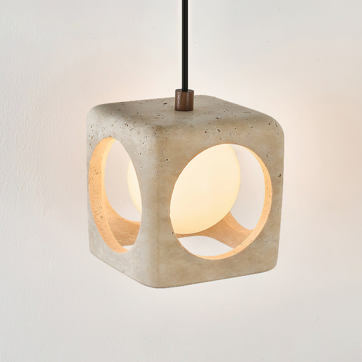 Close-up of the beige travertine stone shade of the pendant light.