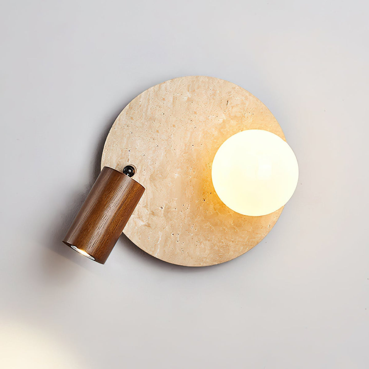 Close-up on the junction between the travertine stone and the light fixture.