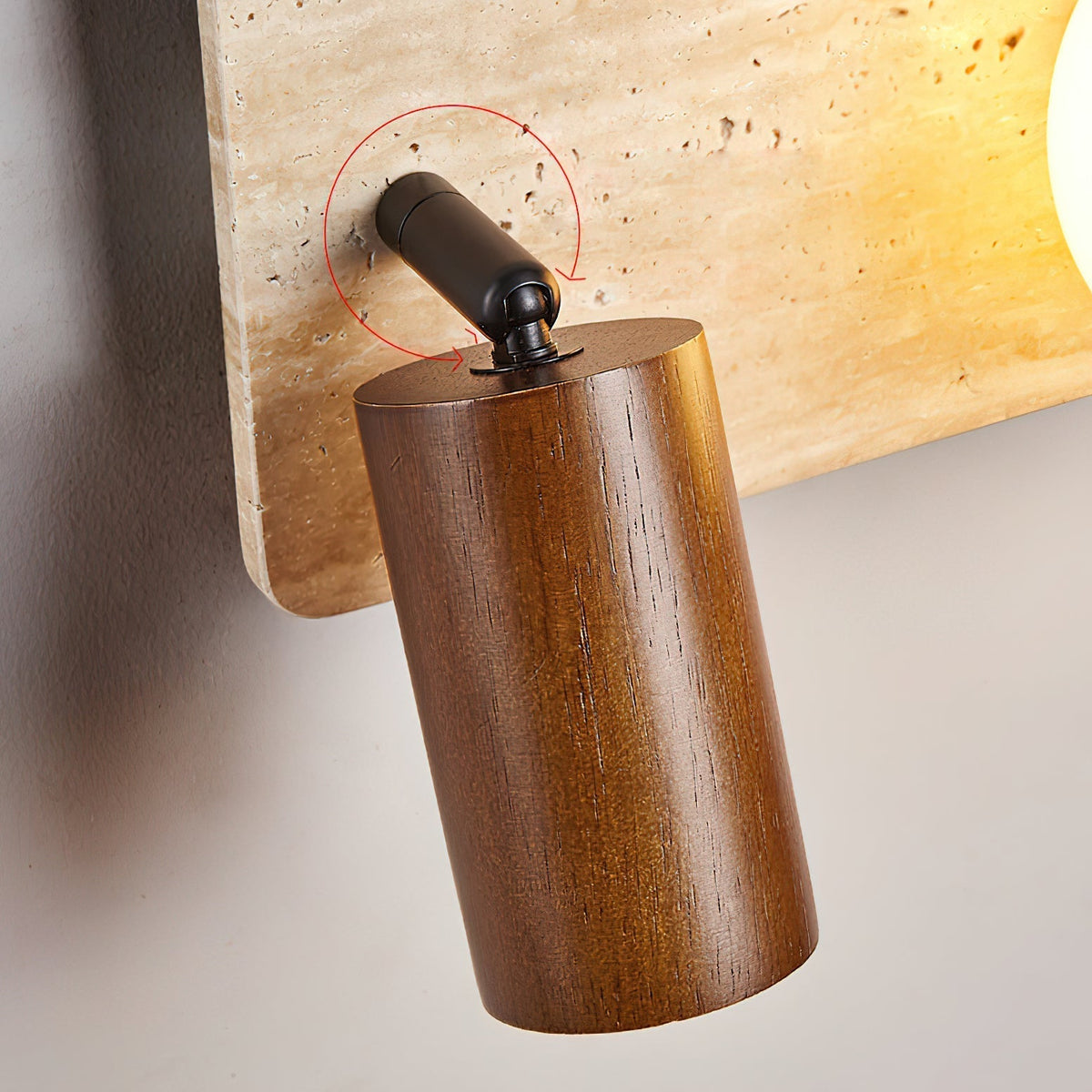 Angled perspective of the Luka Travertine Wall Lamp highlighting its sculptural form.