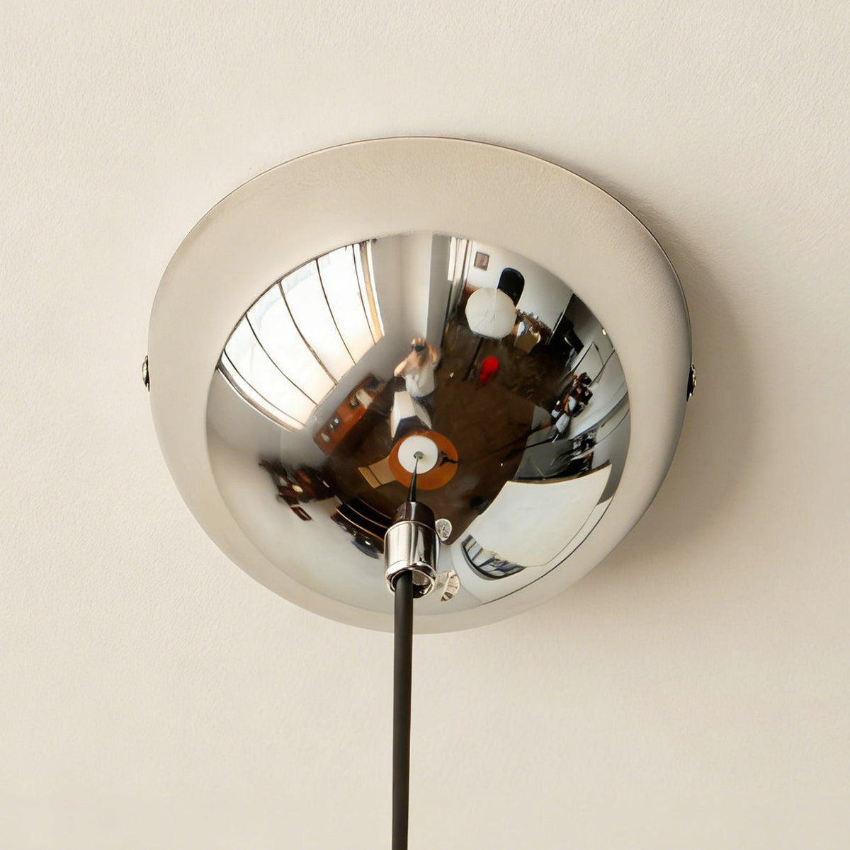The Sia Pendant Light casting a warm glow in an entryway.