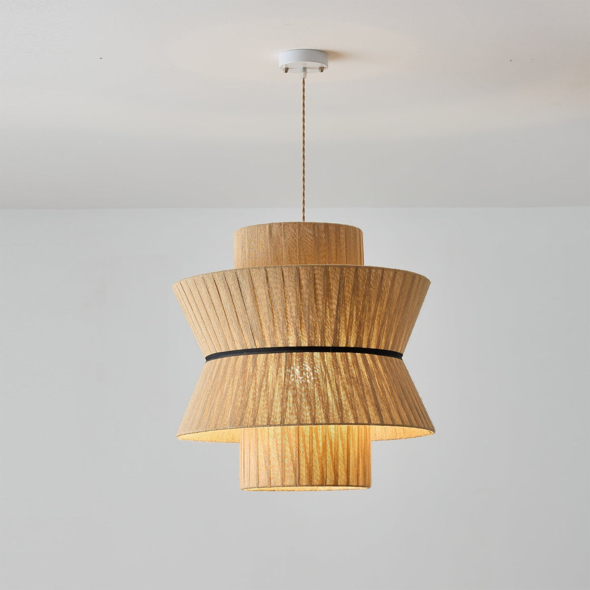 The Sicel Pendant Light illuminated, casting a warm and inviting glow.
