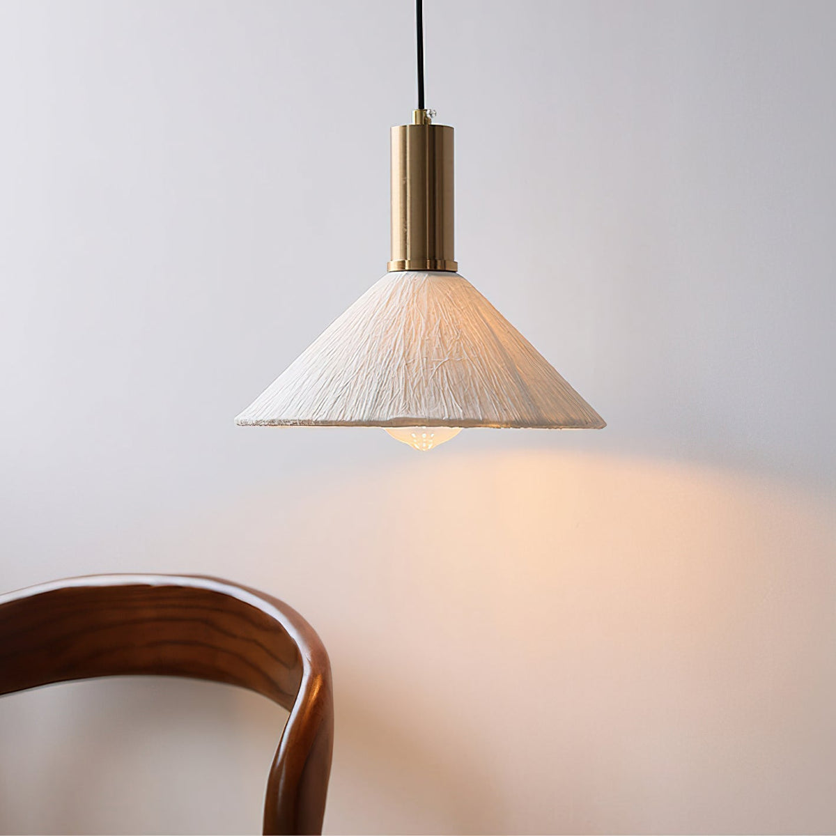 Detail shot of the gold metal accent on the Siya Pendant Light.