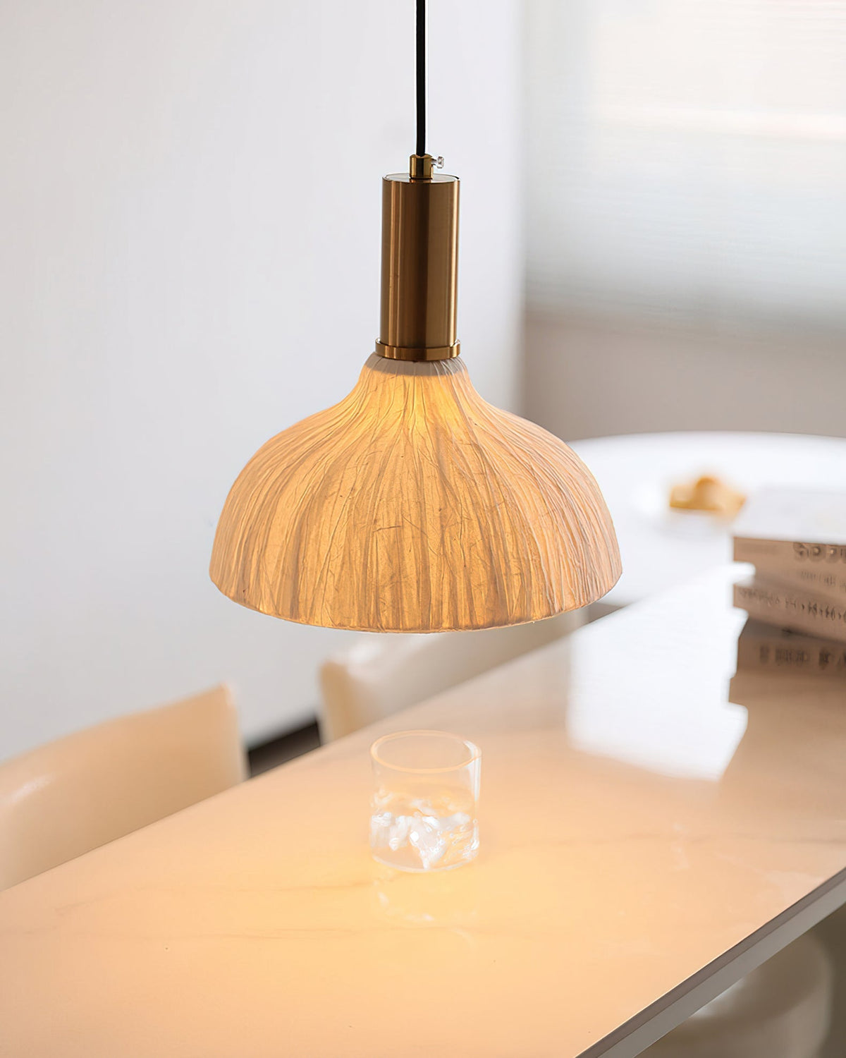 The larger Model B Siya Pendant Light hanging over a dining table.