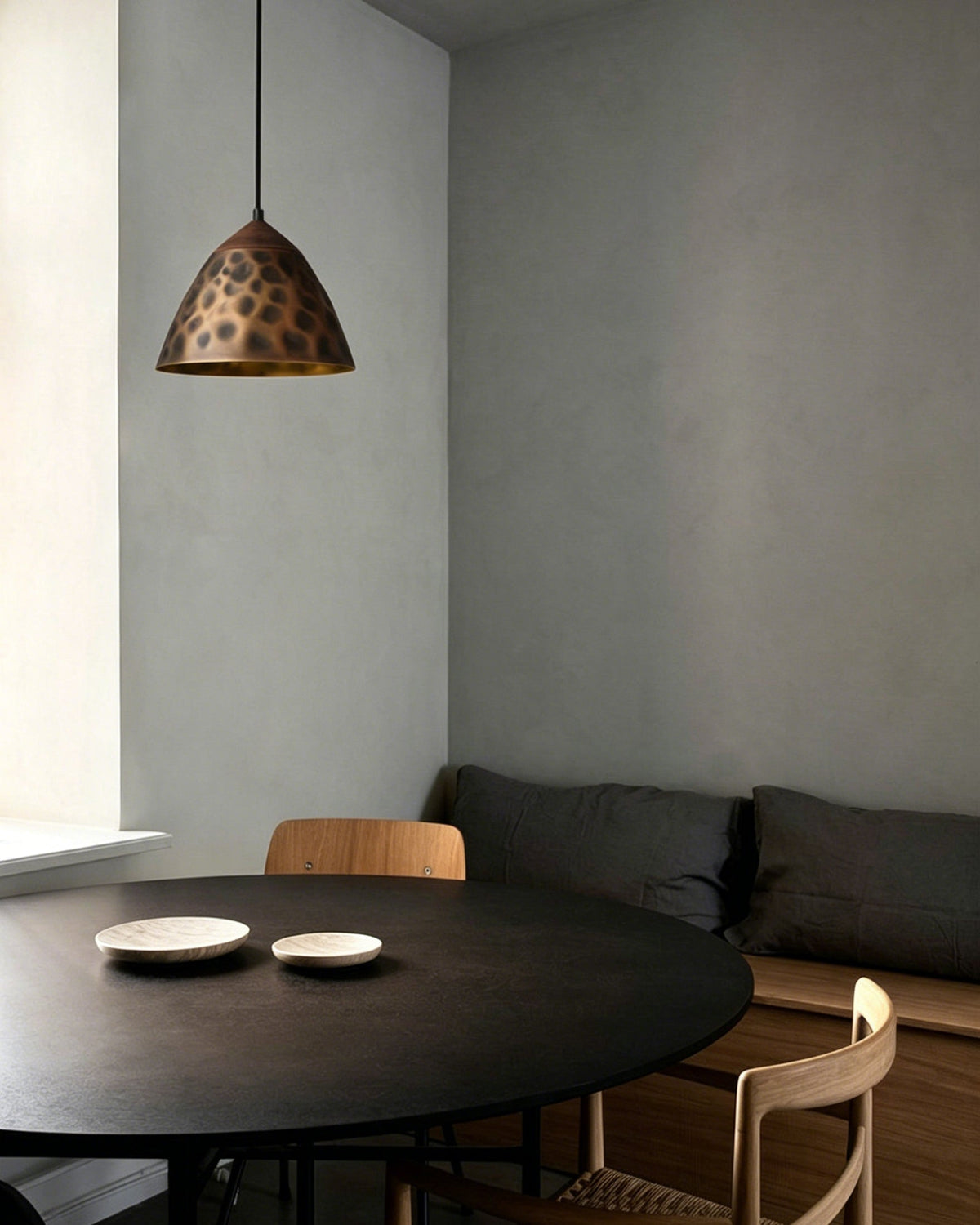 A row of Boyd Brass Pendant Lamps hanging over a modern kitchen island.