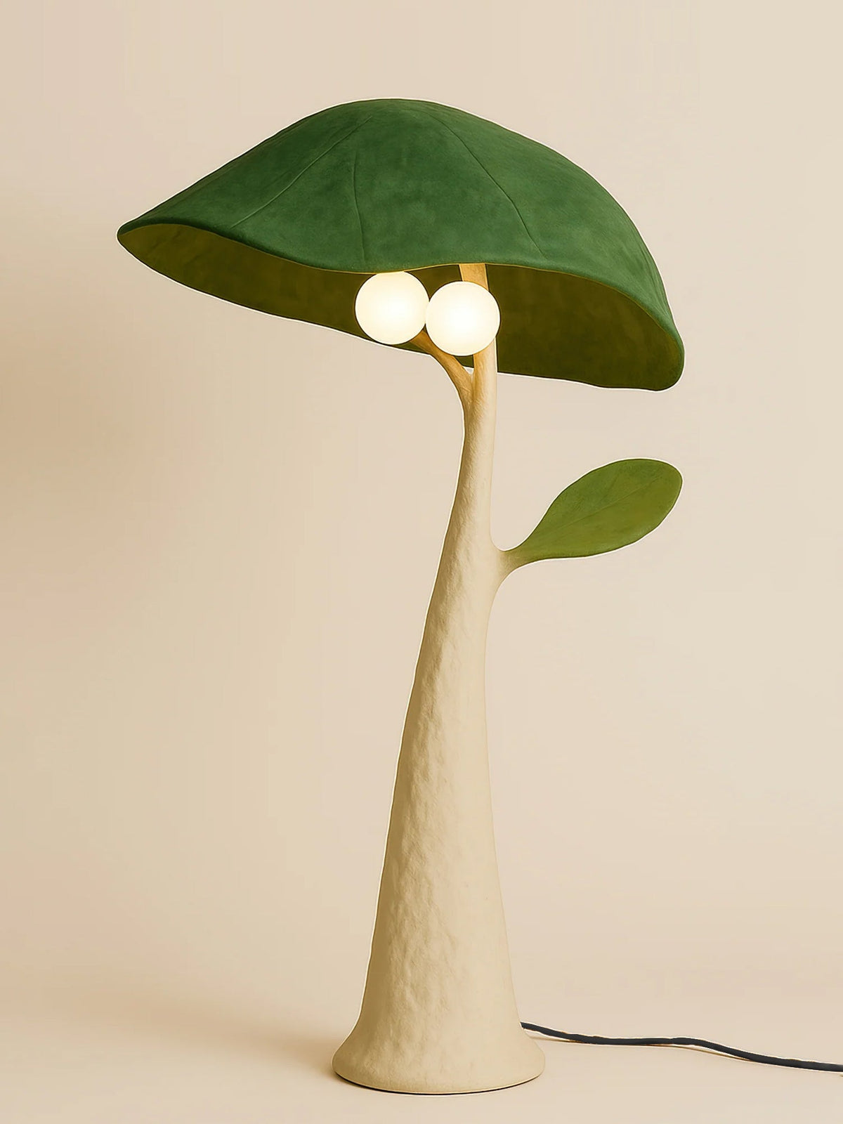 Close-up of the Soloma Floor Lamp's glass shade and green metal base.