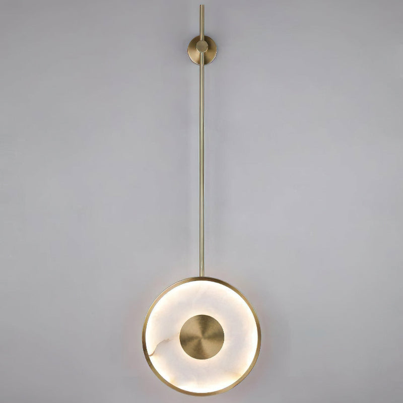The Sorle Alabaster Wall Lamp providing ambient light in a dark room.