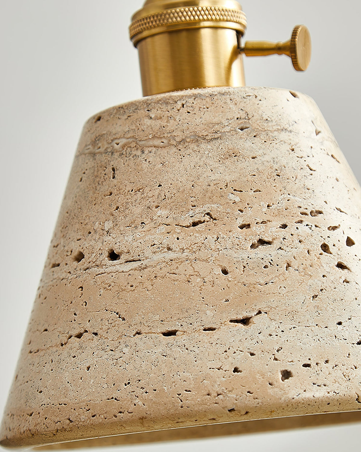 The elegant combination of beige travertine and gold metal finishes.