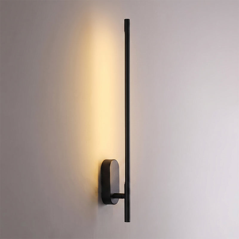 The stick-shaped metal sconce in an oxidized black finish.