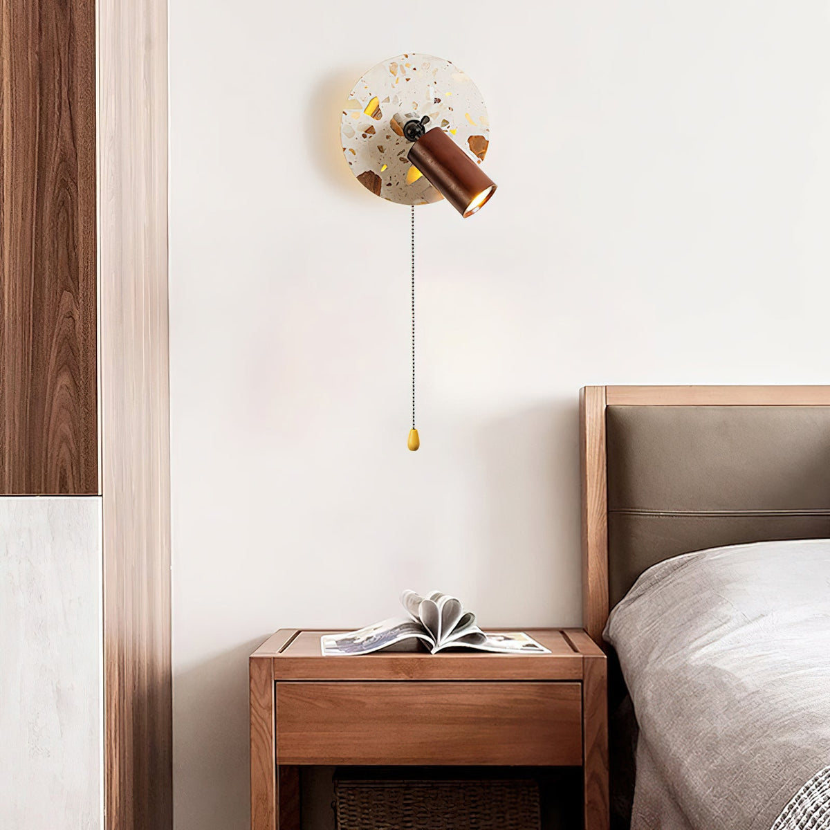 Close-up of the Swizzle Wall Lamp's translucent stone material and wood detail.