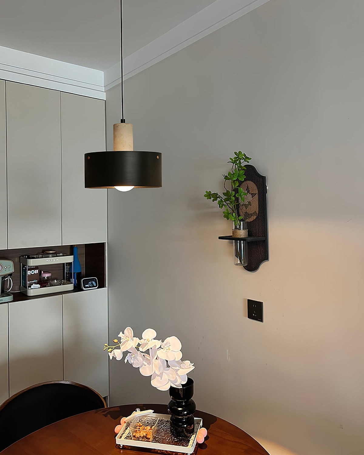 Tako Pendant Lamp shown in the black and beige color option.