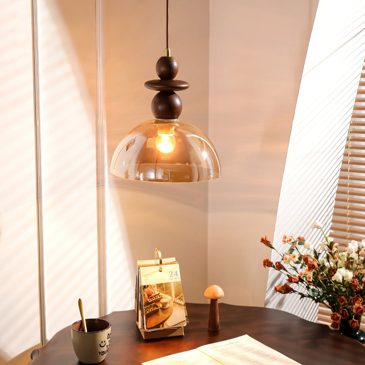 Close-up of the Valeska Pendant Light's sculptural wood and glass details.