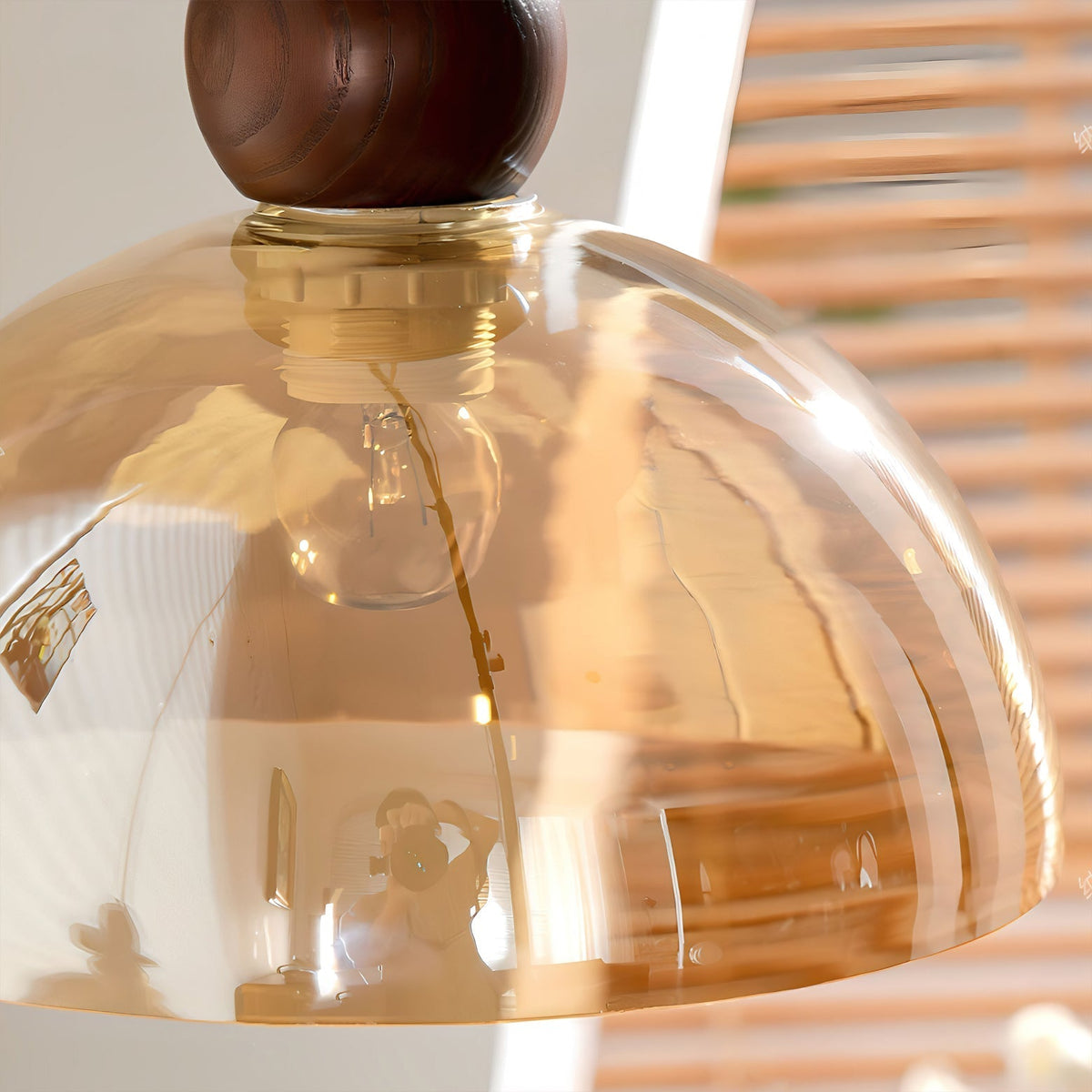 Lifestyle image of the pendant light in a cozy living room corner.