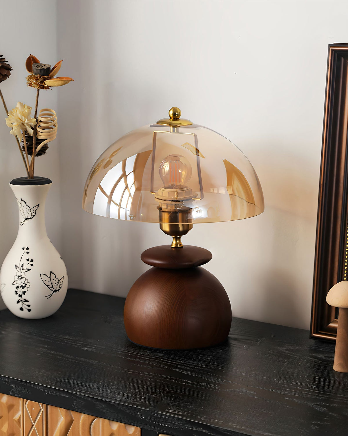 Valeska Table Lamp shown on a bedside table in a modern bedroom.