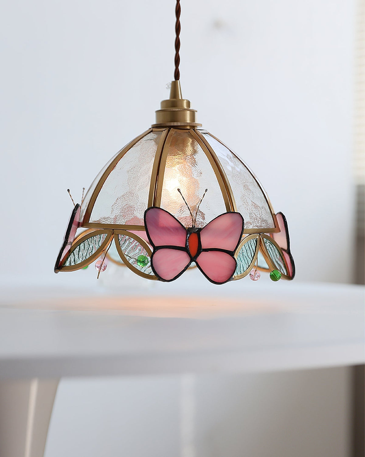 Valinte butterfly pendant light viewed from below, showing the bulb fixture.
