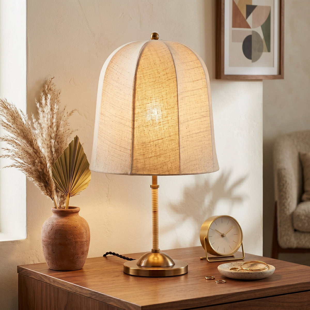 Detail shot of the Vanna Table Lamp's gold metal base and push-button switch.