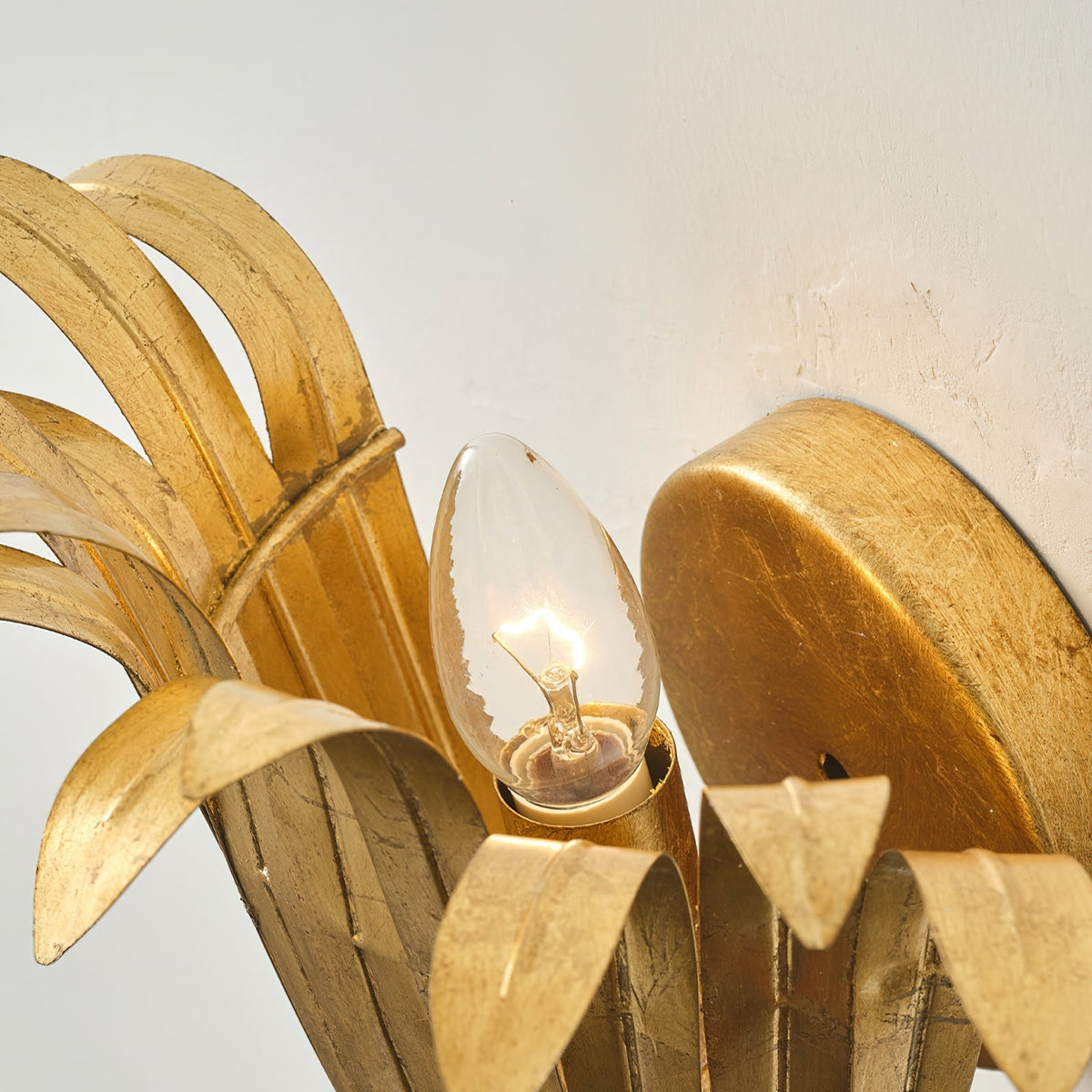 Lifestyle image of the white leaf lamp in a hallway.