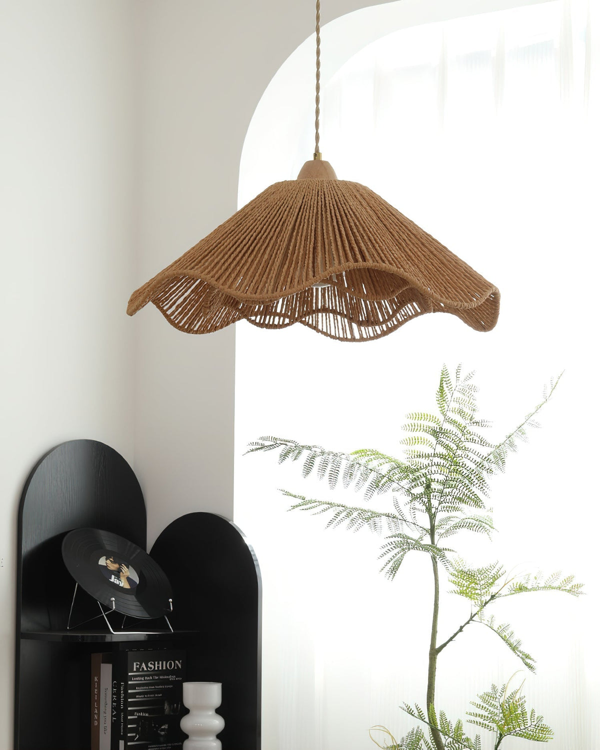 The pendant light casting warm, patterned shadows on a nearby wall.
