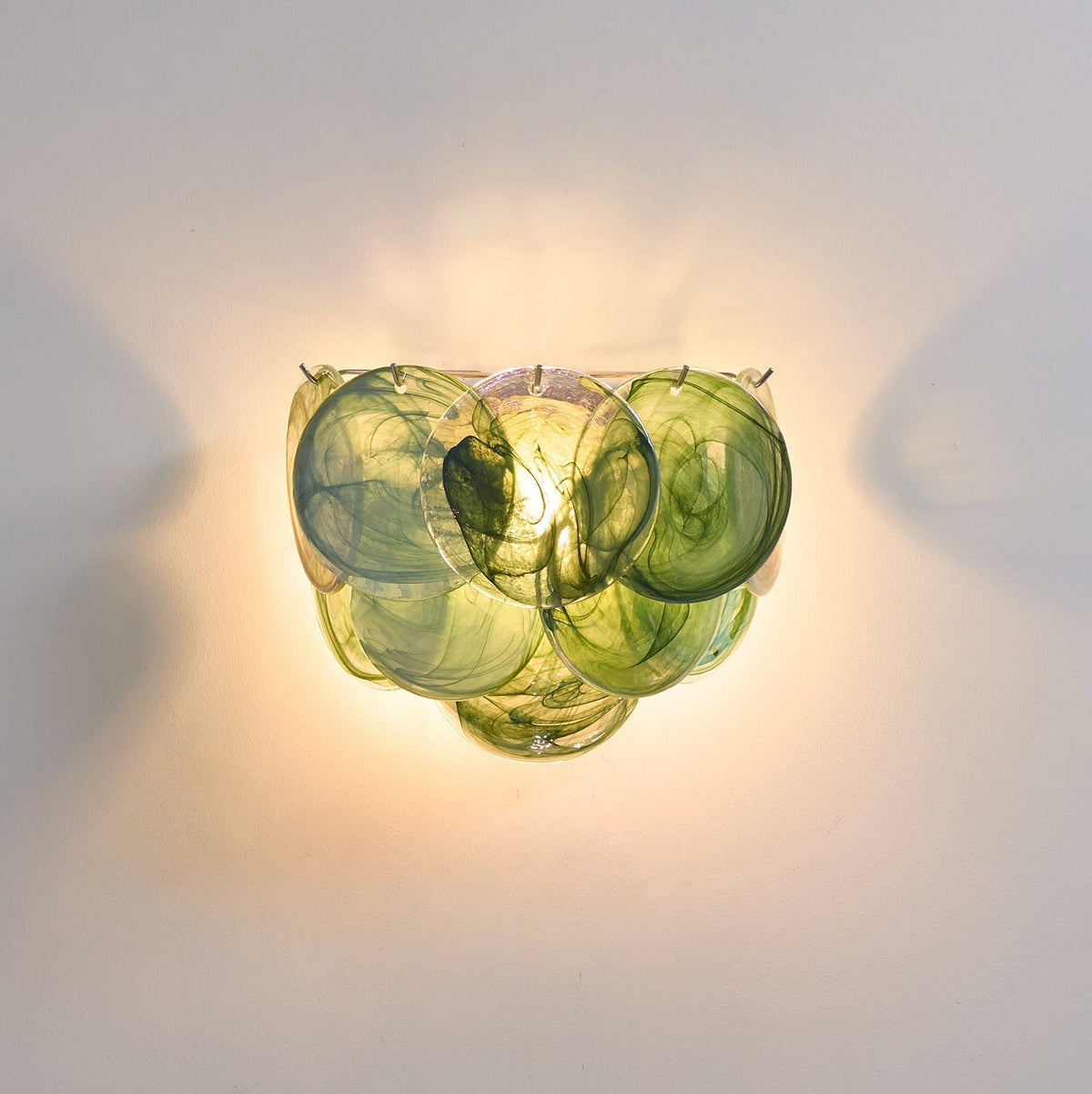 Vistosi Disc Wall Lamp in blue glass, shown in a hallway.