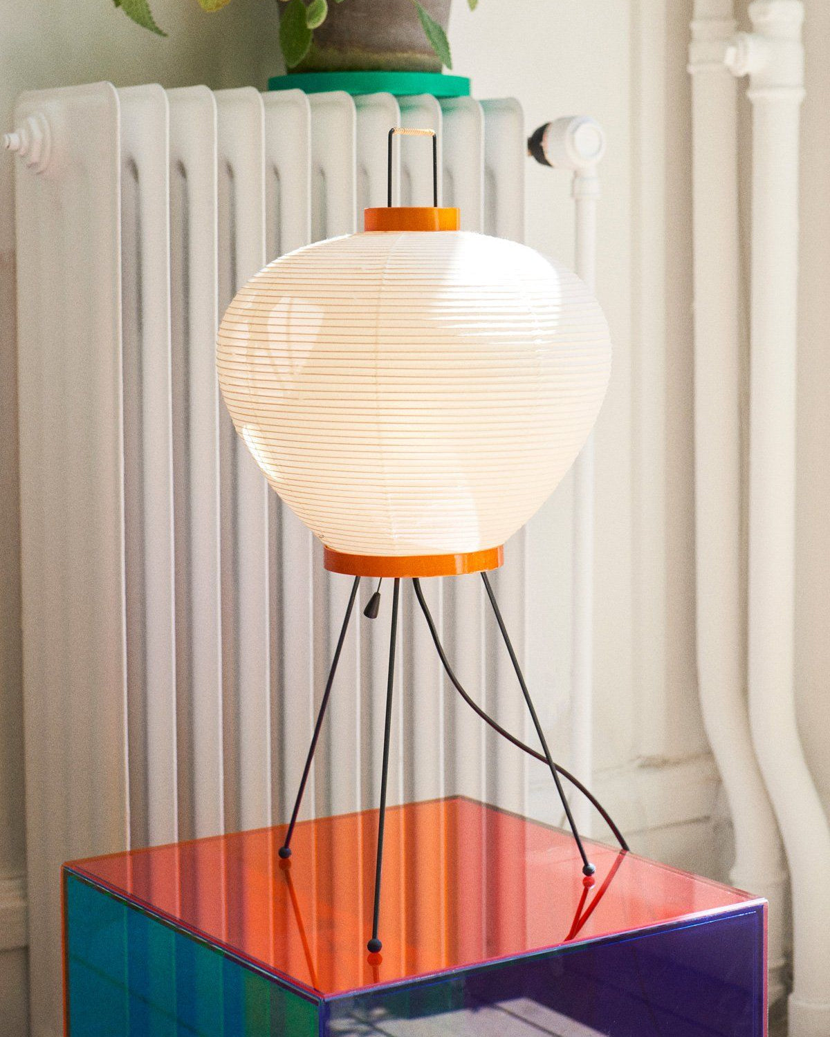 The Washi 3A Table Lamp illuminated, casting a warm, diffused glow.