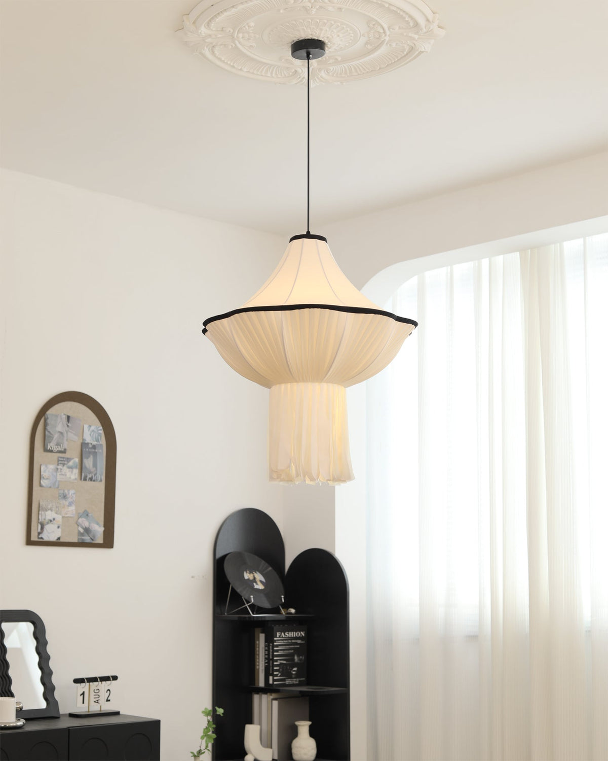A large Wildon Pendant Light making a statement in a room with high ceilings.