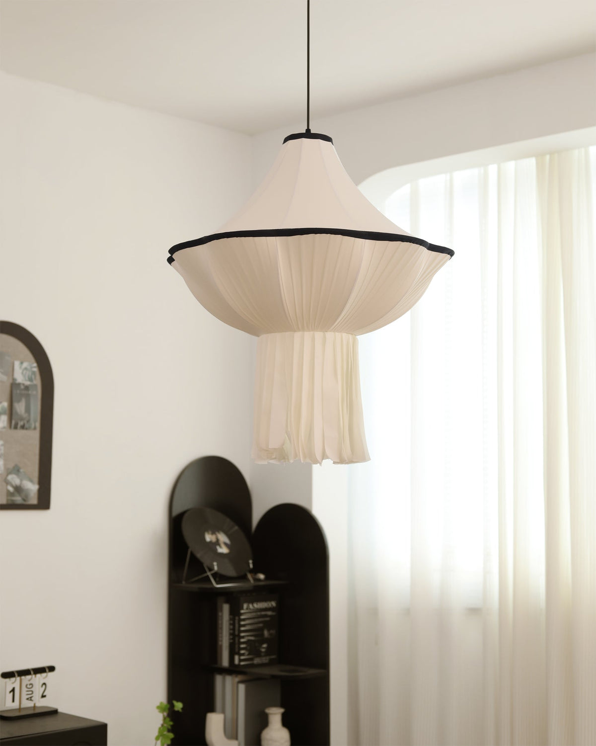 Side view of the sculptural Wildon Pendant Light against a neutral wall.
