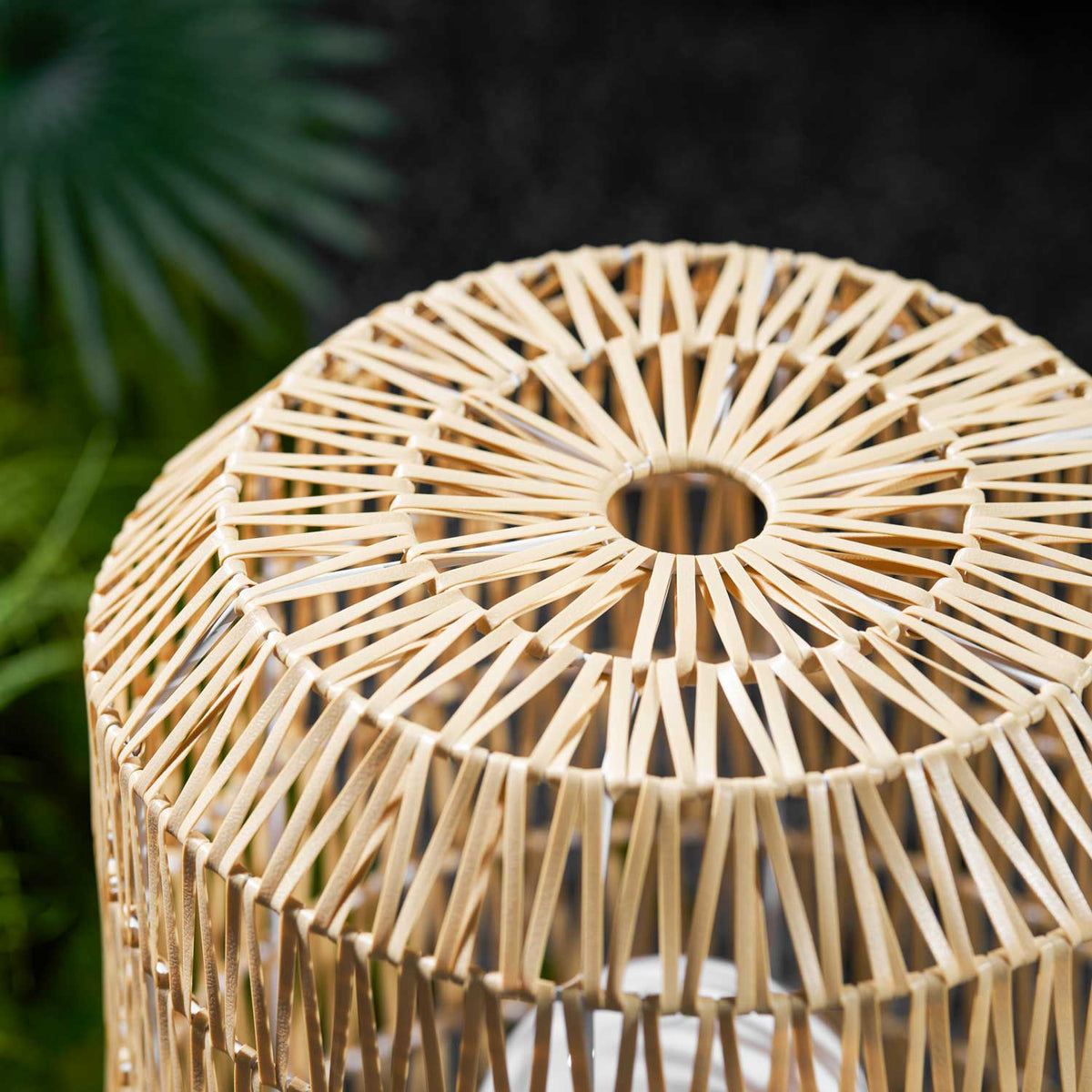 Angled view of the bohemian-style rattan outdoor lamp.
