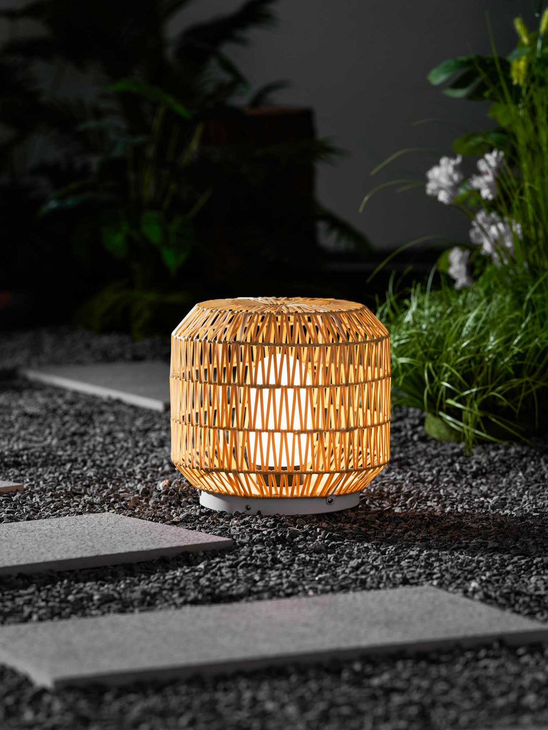 Angled view of the bohemian-style rattan outdoor lamp.